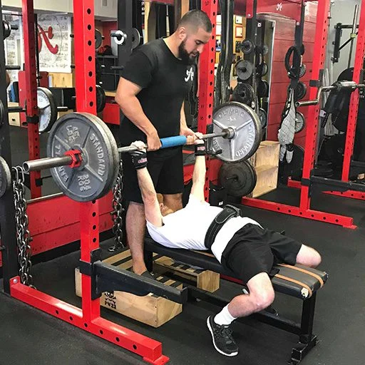 Photo of trainer Brendan with his client bench pressing