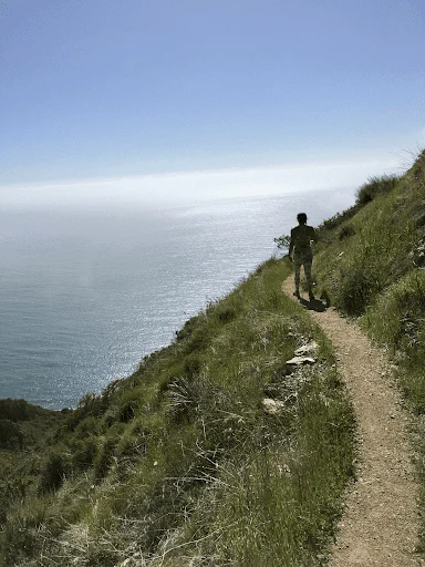 a person on a path by water