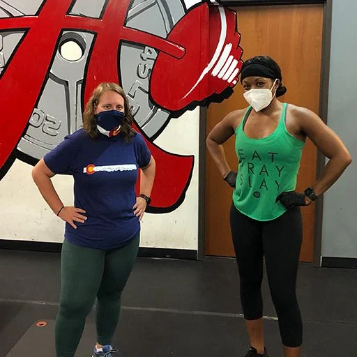 client highlight posing with her trainer.