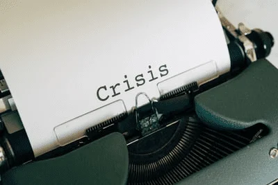 image of a typewriter with the word crisis