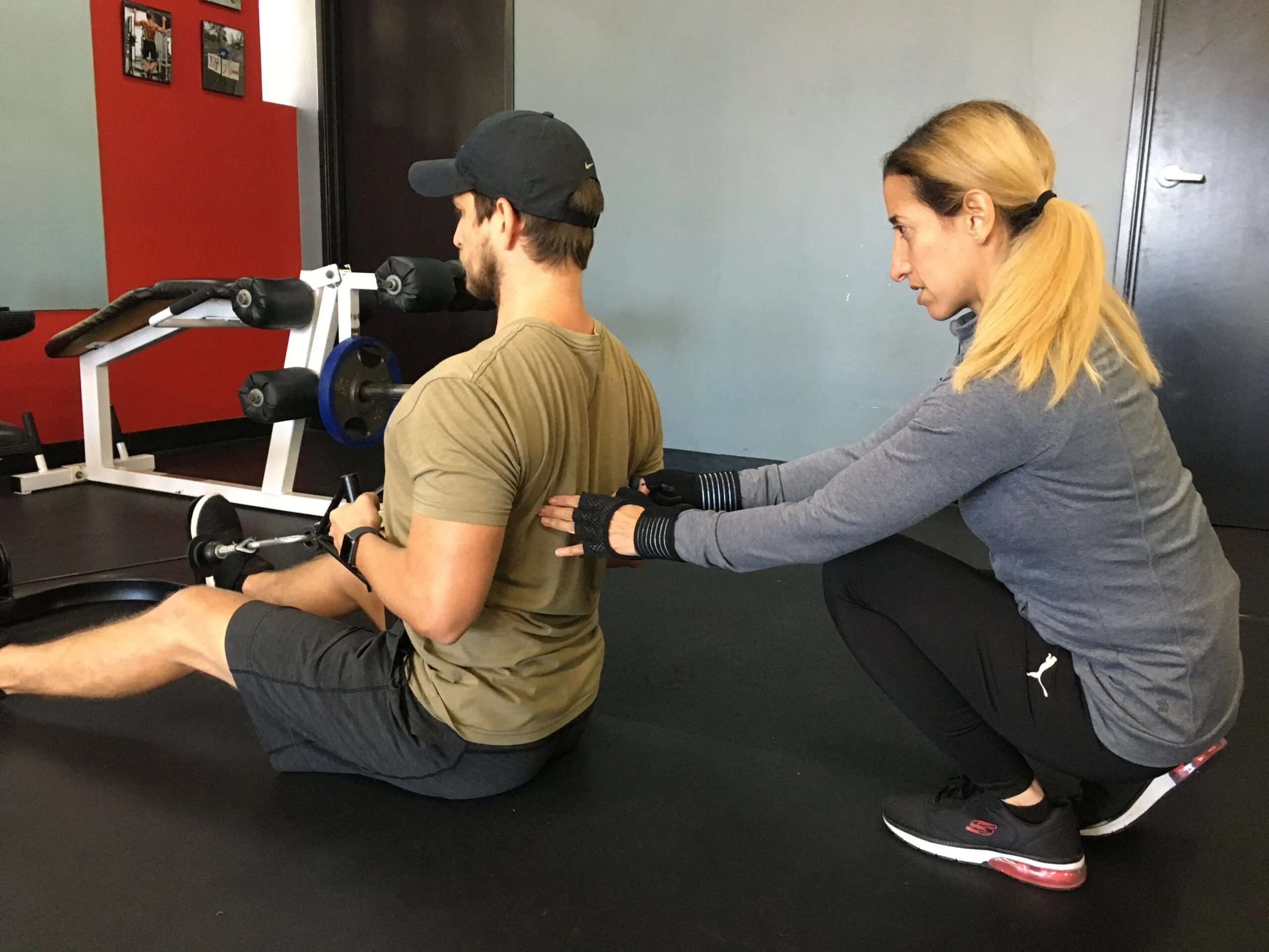 Vilita Cruz assisting client with proper form to aid in bone density