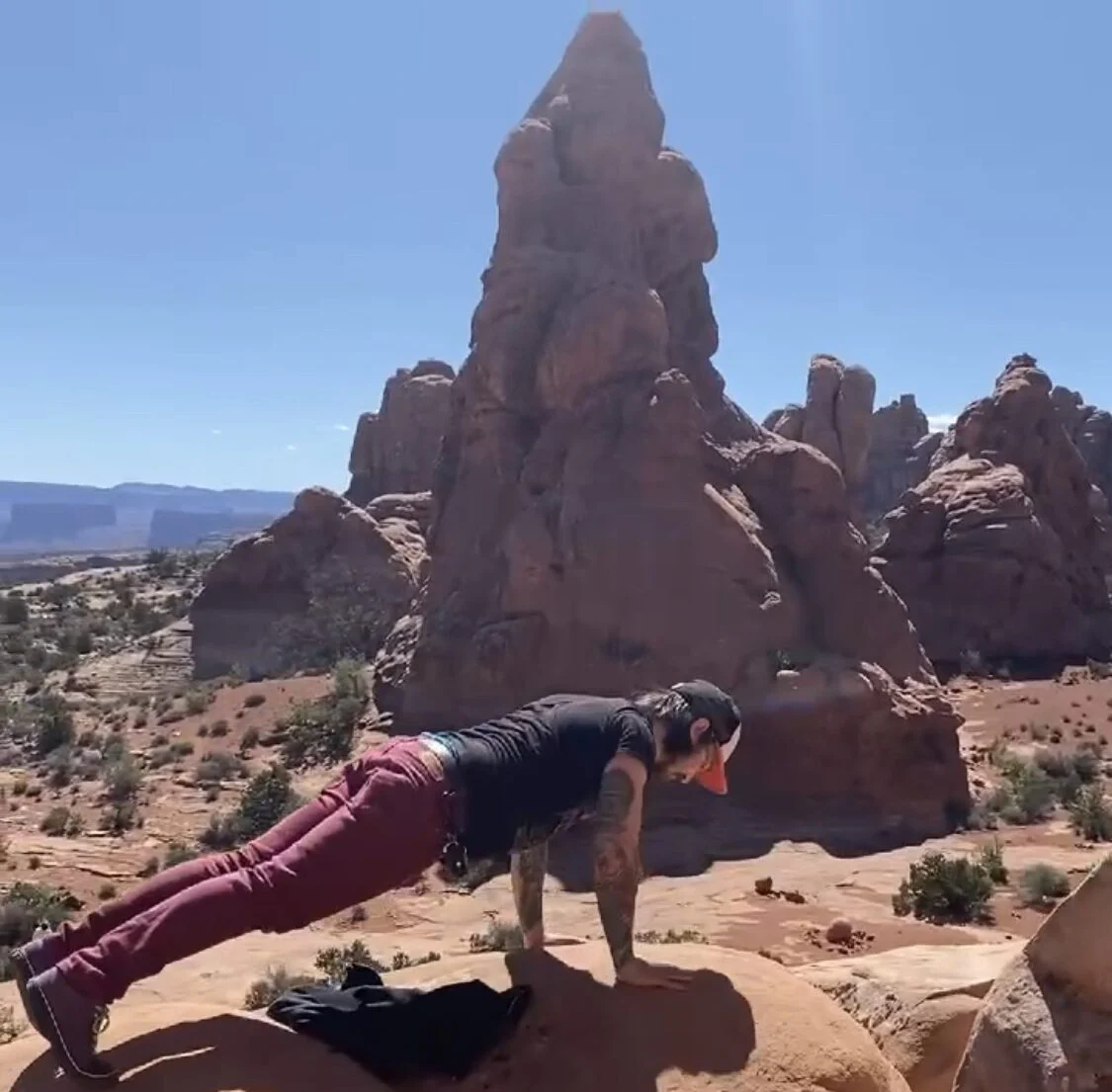 Nicky doing a plank in a beautiful location