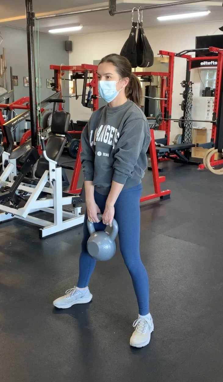 Client highlight performs kettlebell deadlift