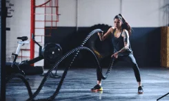 Woman using battle ropes with a strong mindset