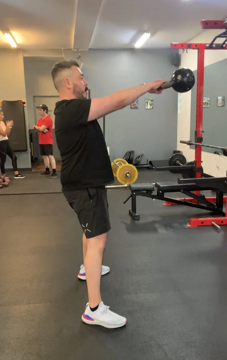Johnny performing a kettlebell swing