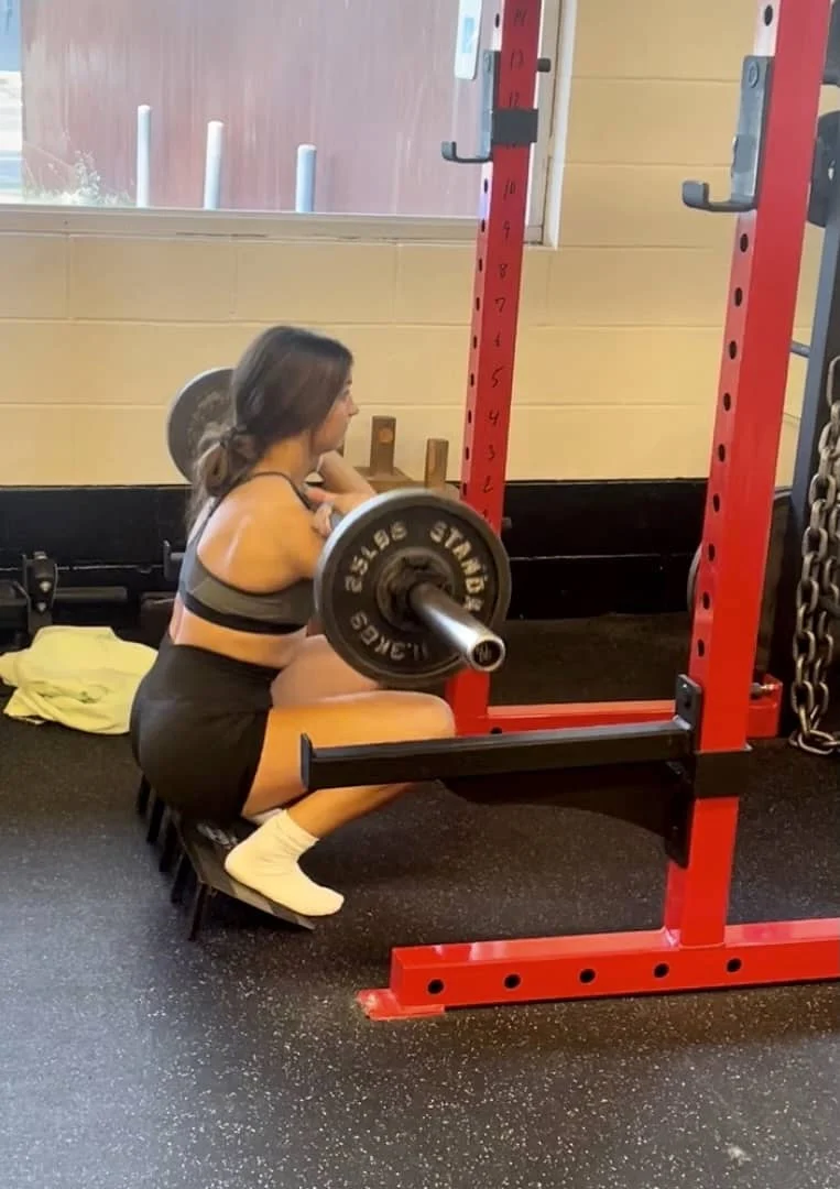 Molly performing a front squat