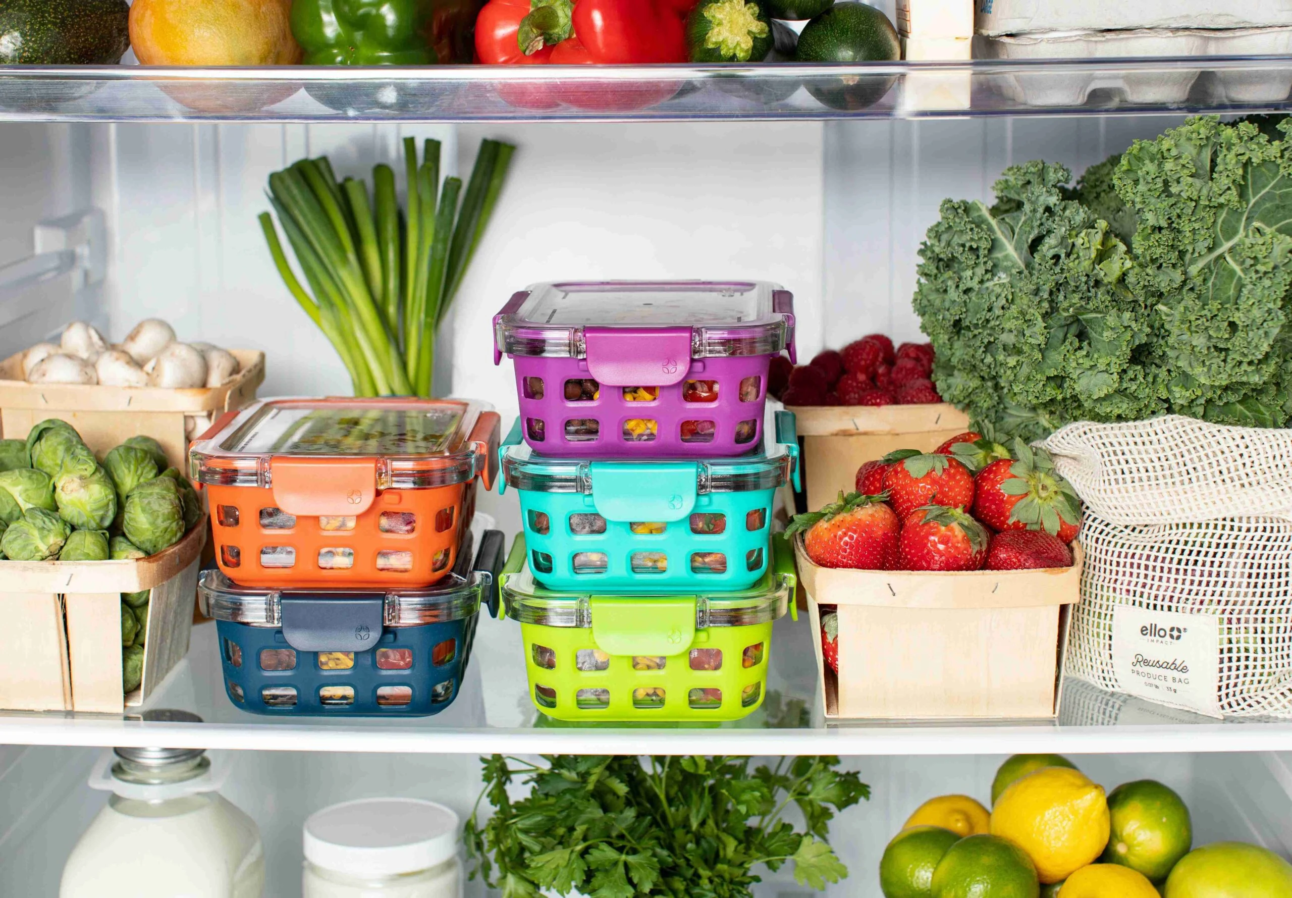 Prepared meals, mushrooms, Brussels sprouts, strawberries, peppers, lemons and limes in a refrigerator