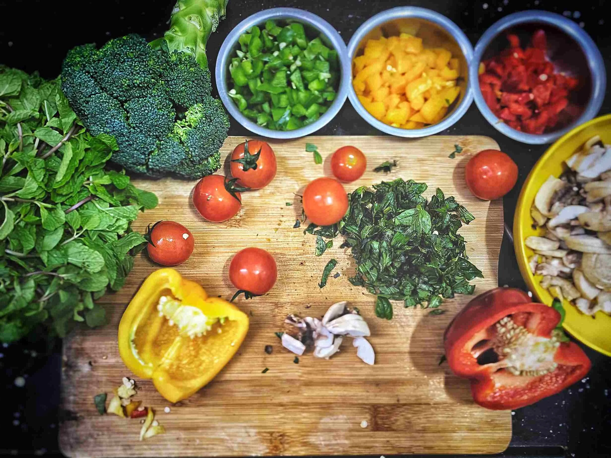 Peppers, tomatoes, broccoli on a chopping board