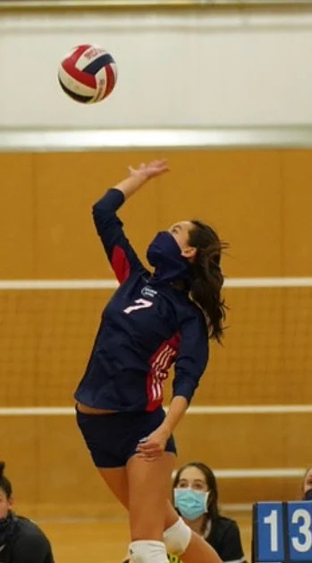 Hadley spiking a volleyball