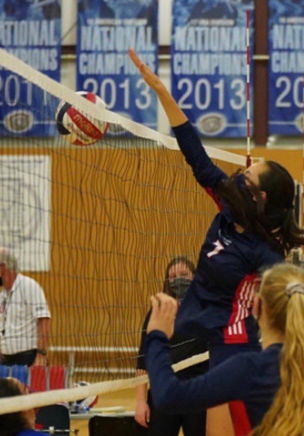 Sports performance client spiking a volleyball