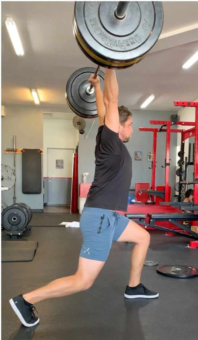 Personal trainer lifting weights with success