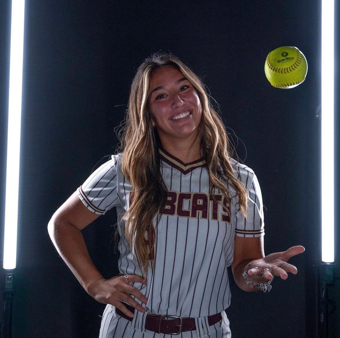 Athlete Maddy tossing a softball