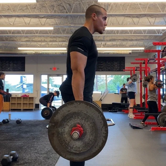 Personal trainer Eric Brooks improving his health and fitness by performing a deadlift