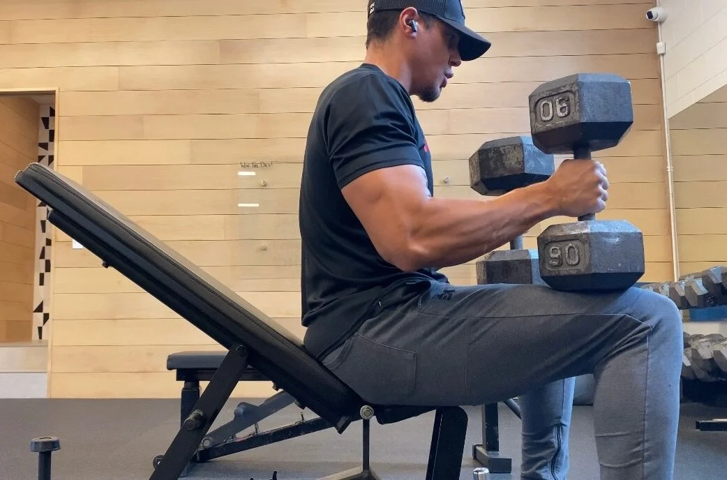 Personal trainer Eric Brooks preparing to do a dumbbell bench press