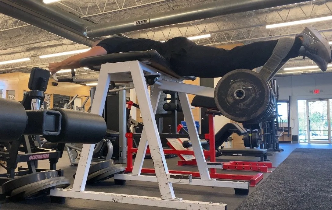 Personal trainer Eric Brooks improving his health and fitness by performing a reverse hyperextension