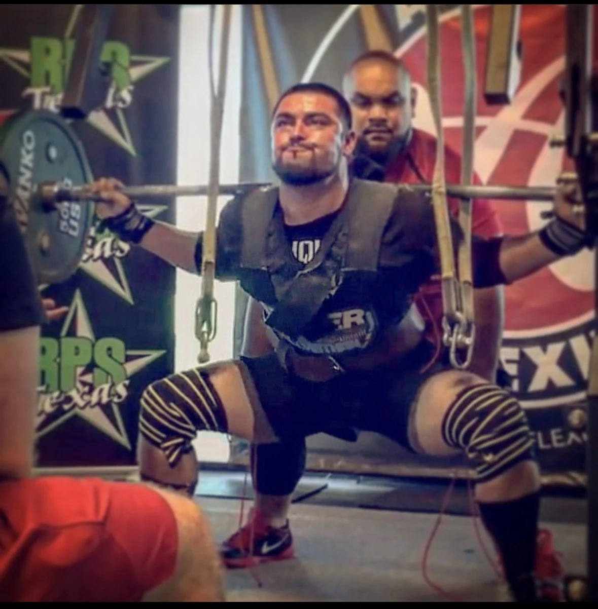 Brendan doing a squat in a powerlifting meet