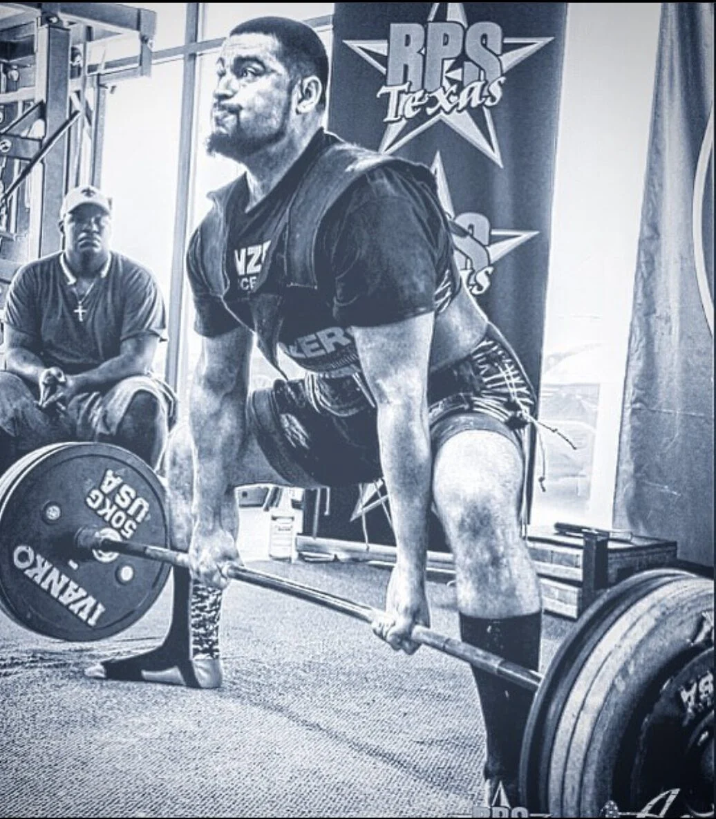 Brendan doing a deadlift at a powerlifting meet