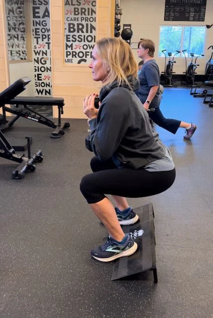 Client highlight doing a squat