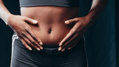 A person with their hands on their stomach