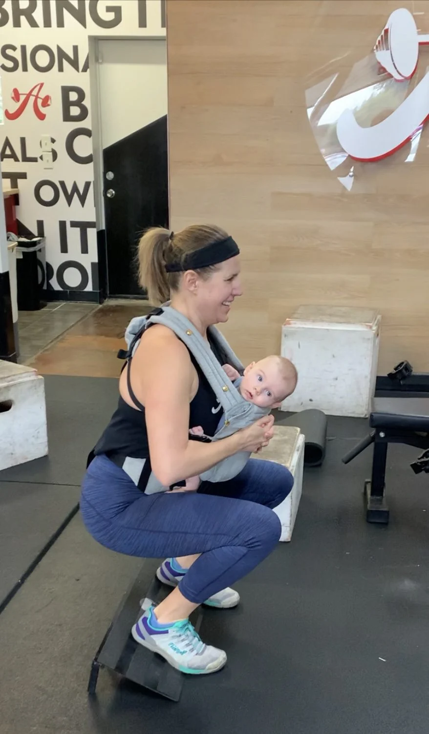 A woman client squatting with her baby