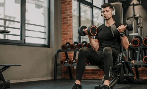 a person performing seated biceps curls