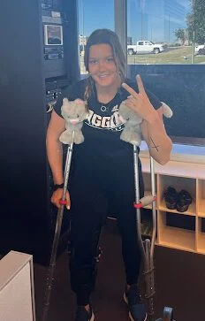 Bailee standing with crutches, focusing on small wins