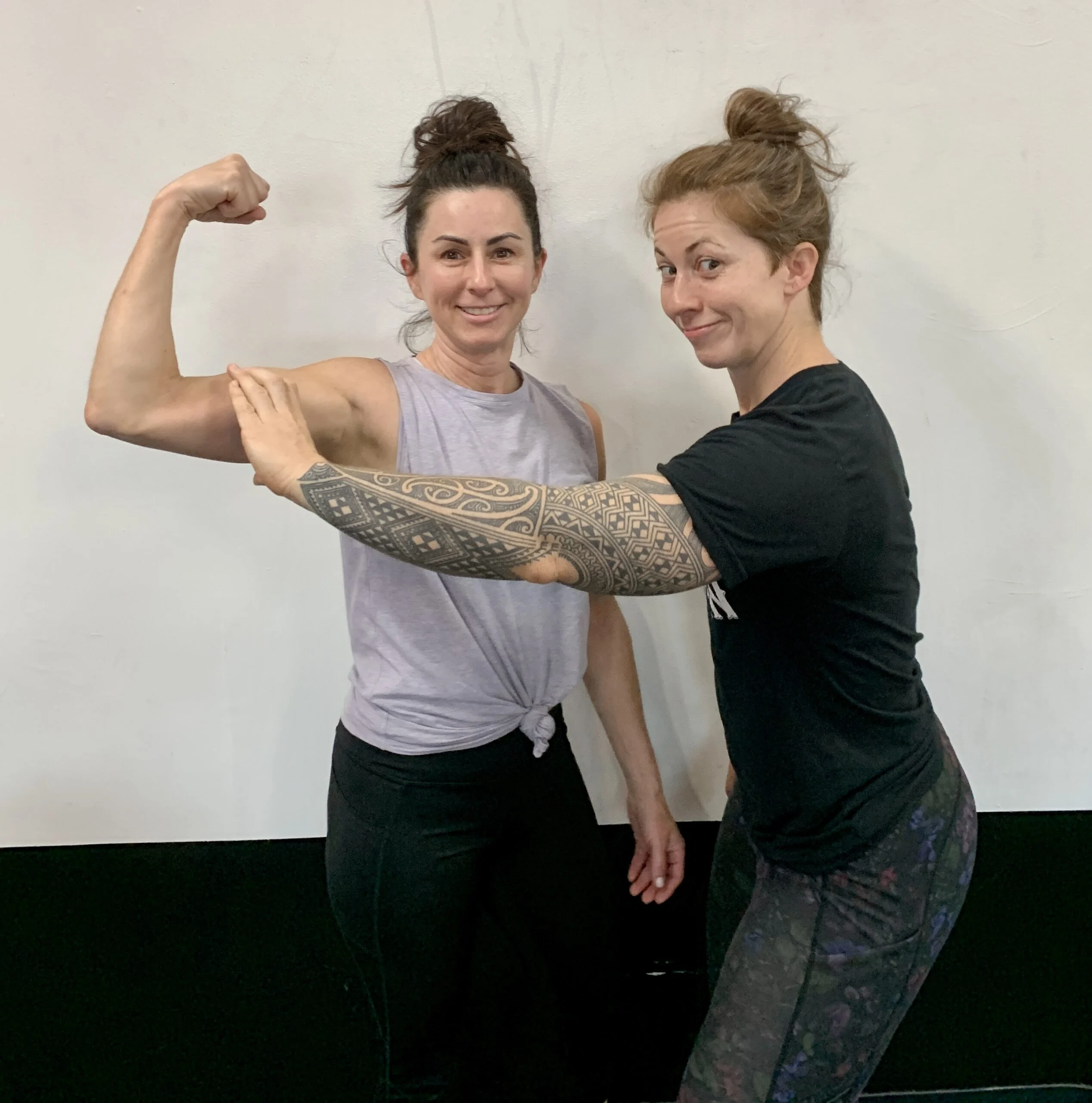 client highlight and her trainer flexing