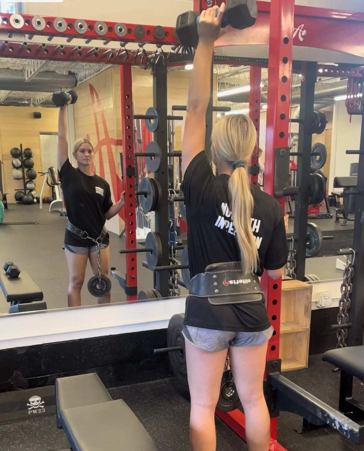 Client doing a dumbbell overhead press