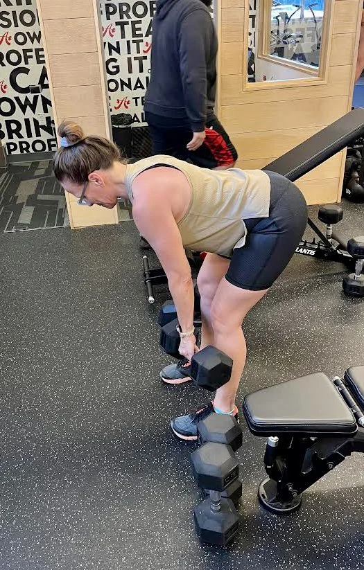 client doing a dumbbell Romanian deadlift