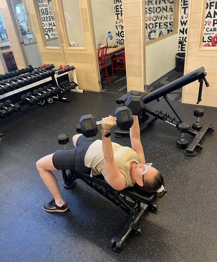 Person doing a dumbbell bench press