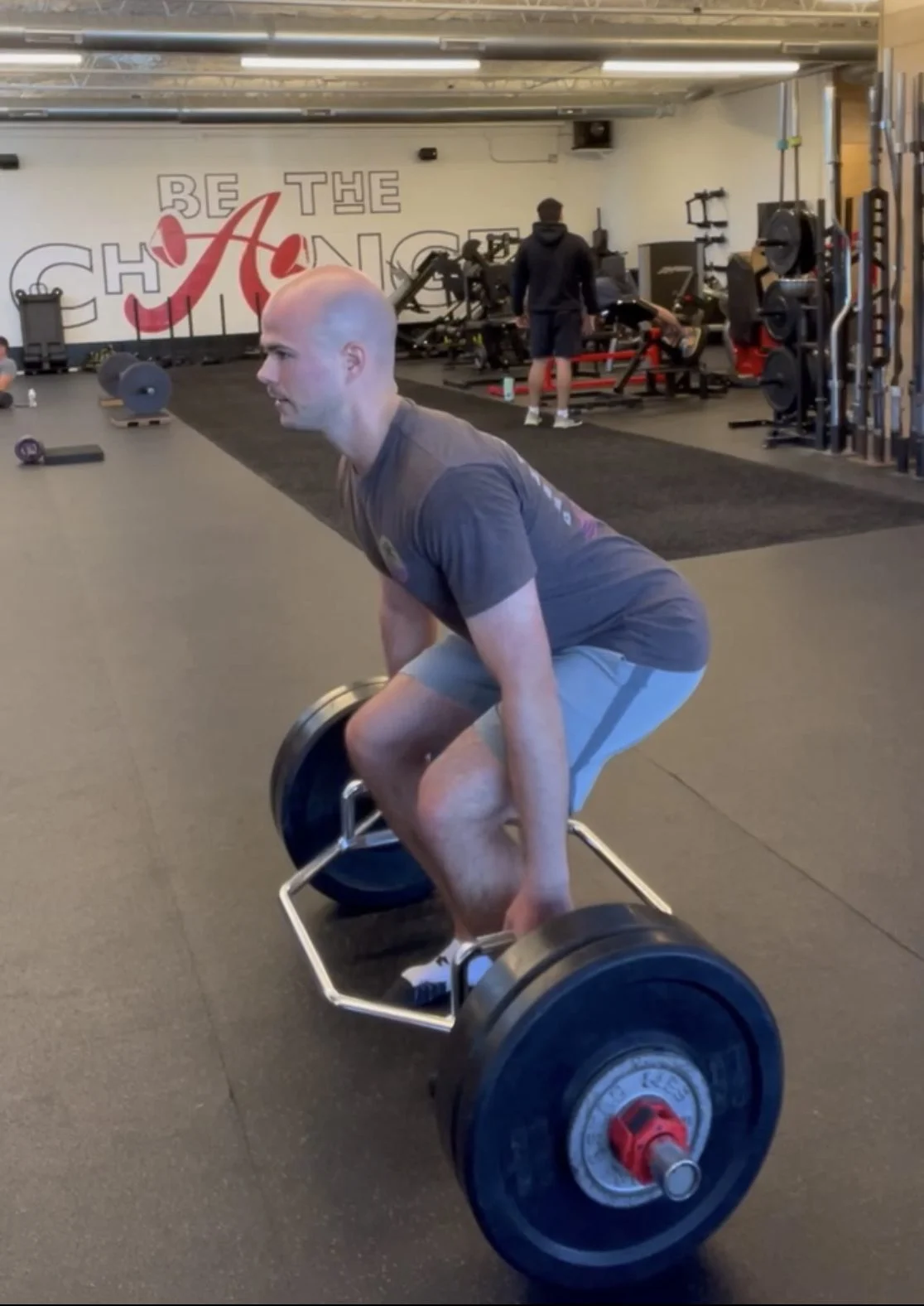 client performing a trap bar deadlift
