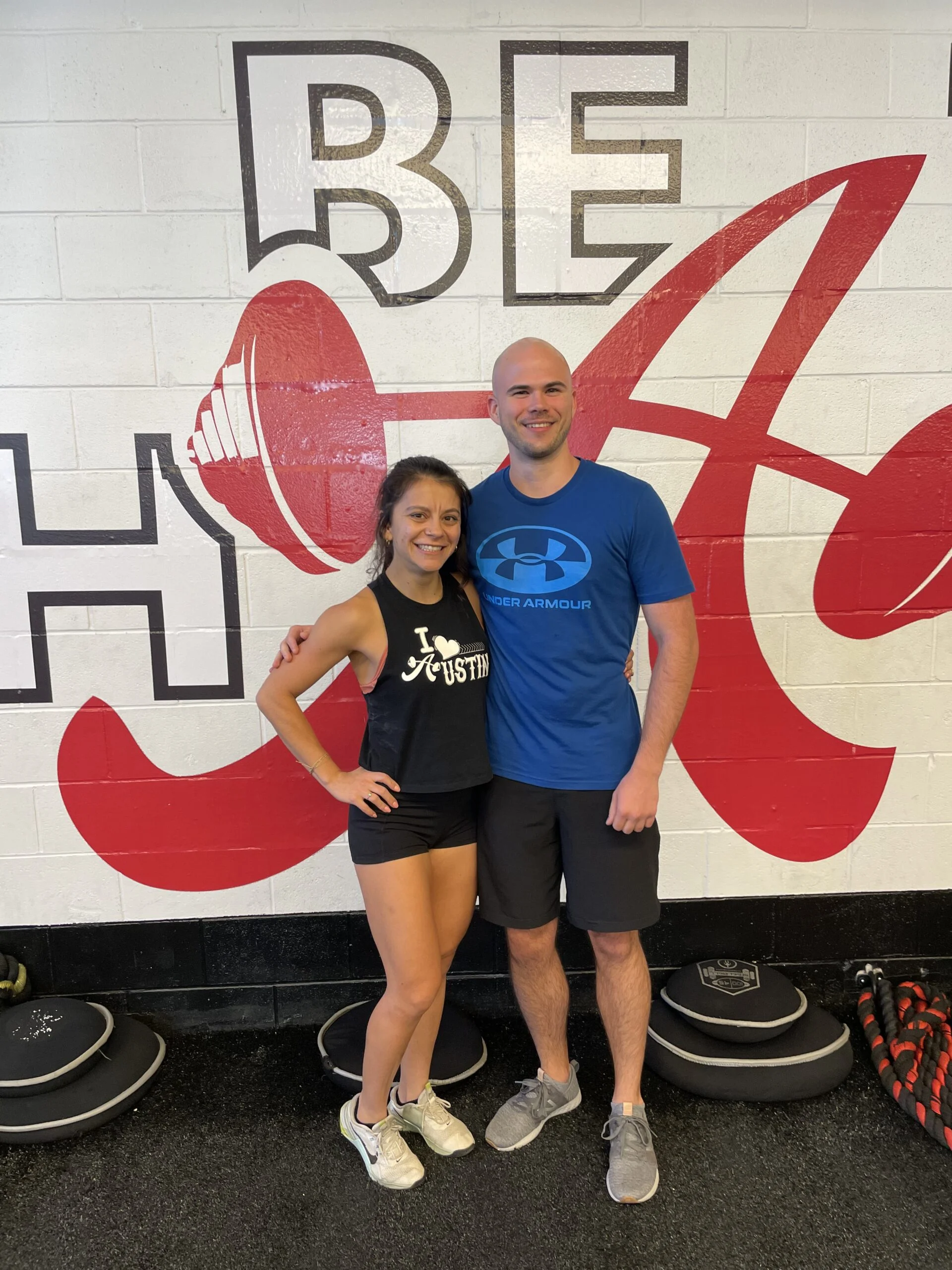 client highlights posing with his trainer