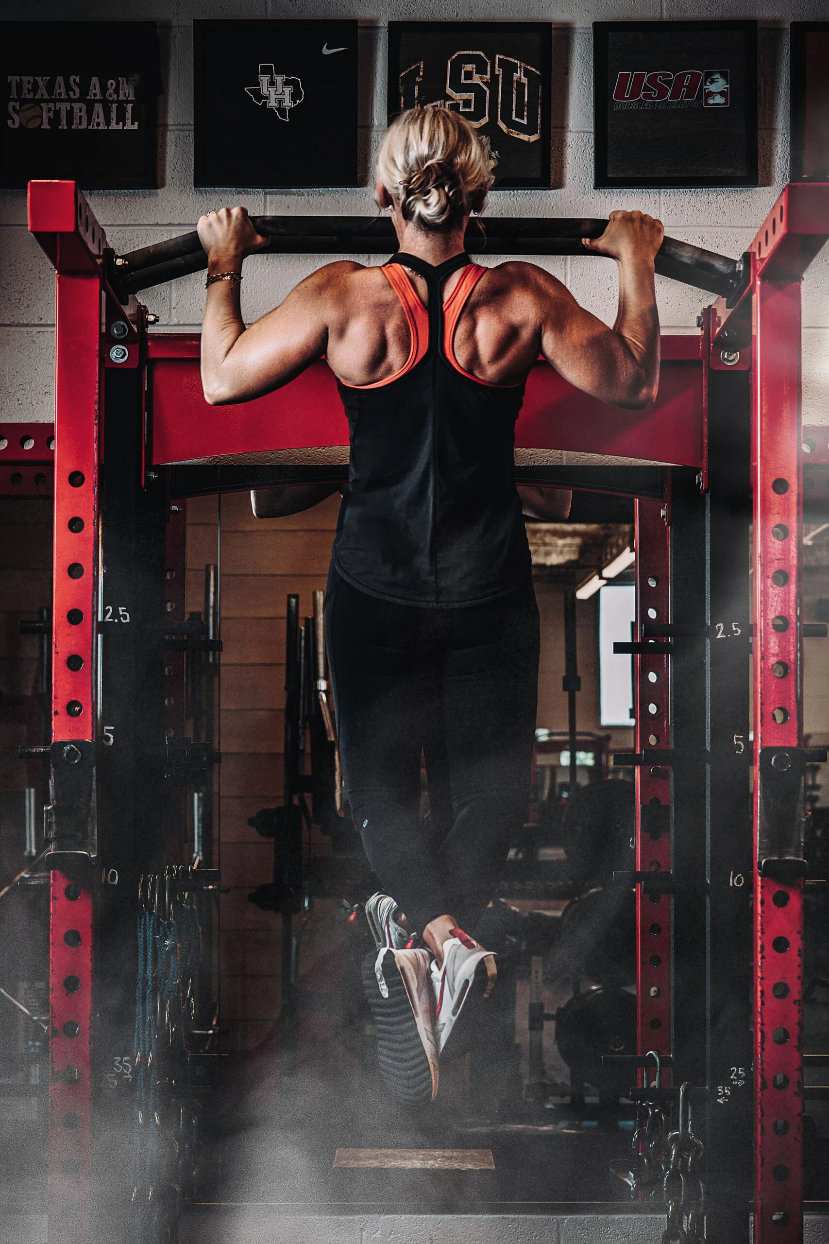 Personal trainer Krista Bergeron performing a pull up 