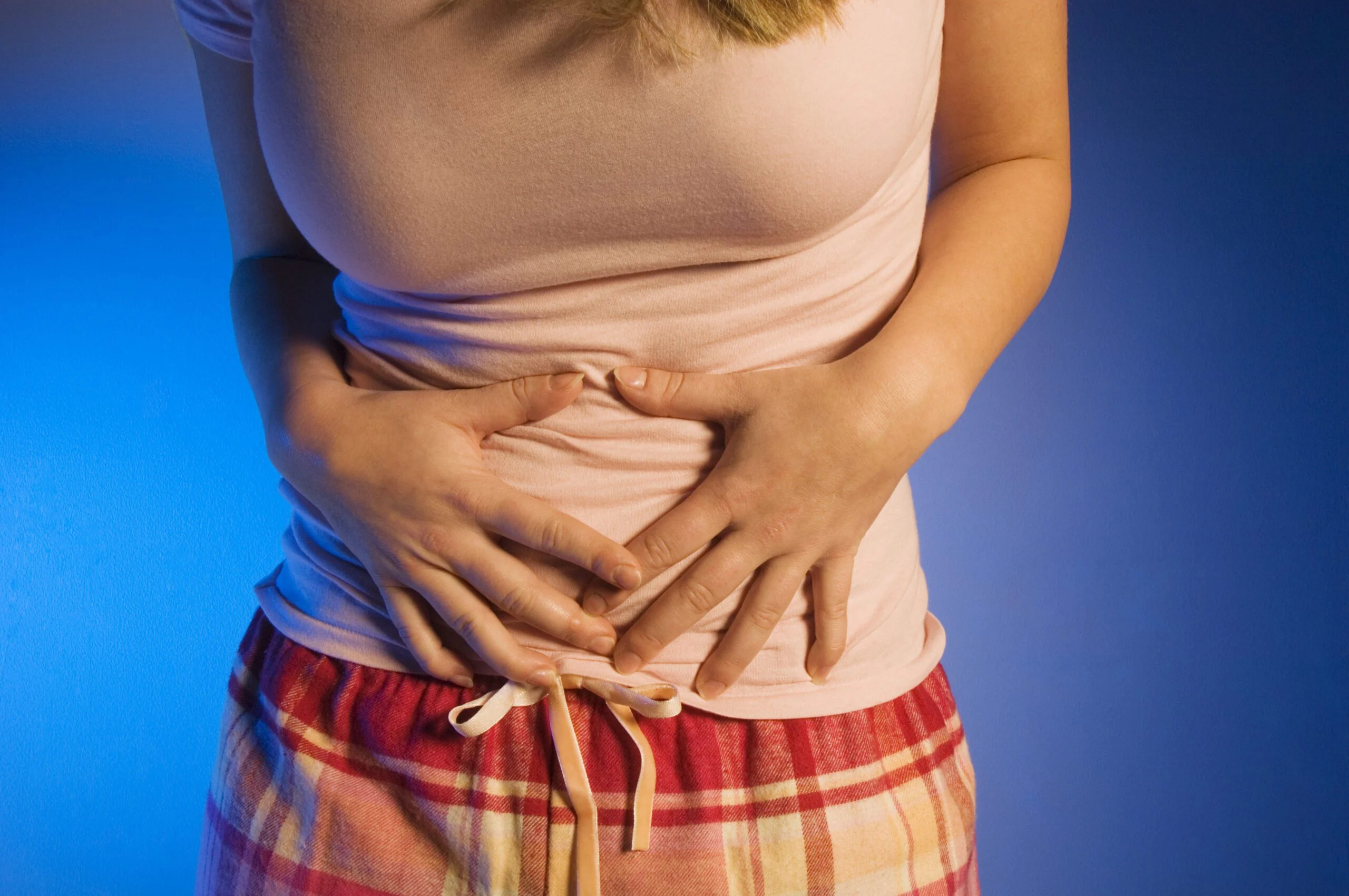 A woman experiencing cramps during her monthly cycle