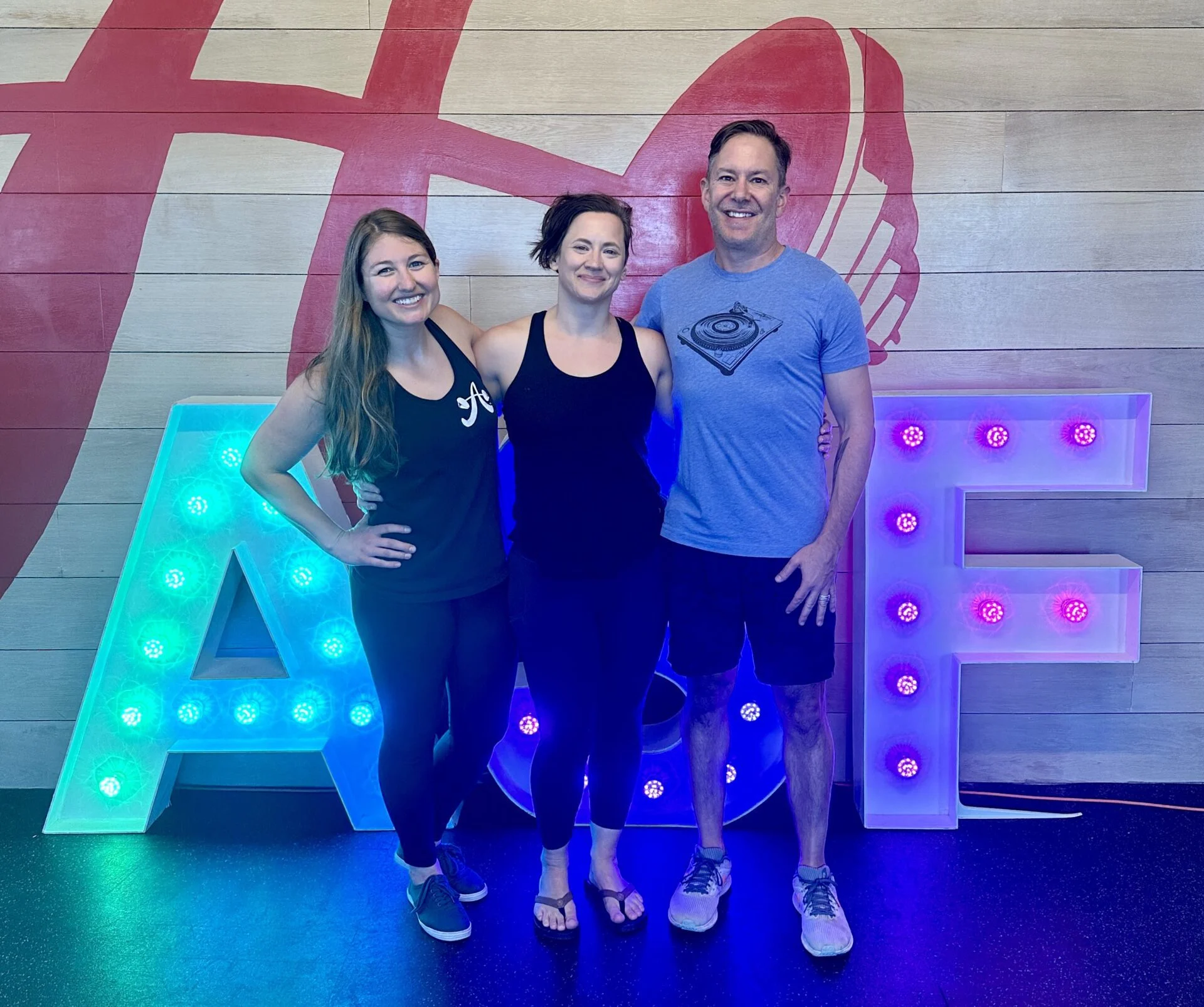 Clients and their trainer in front of an ASF marquee