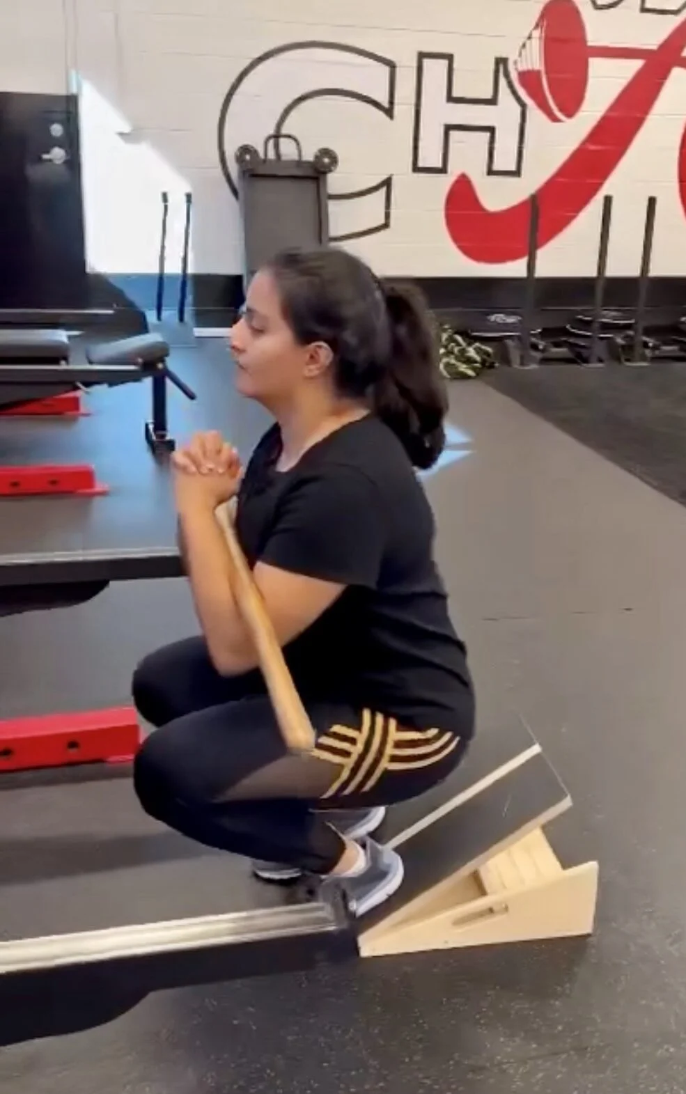 client highlight performing a Zercher squat