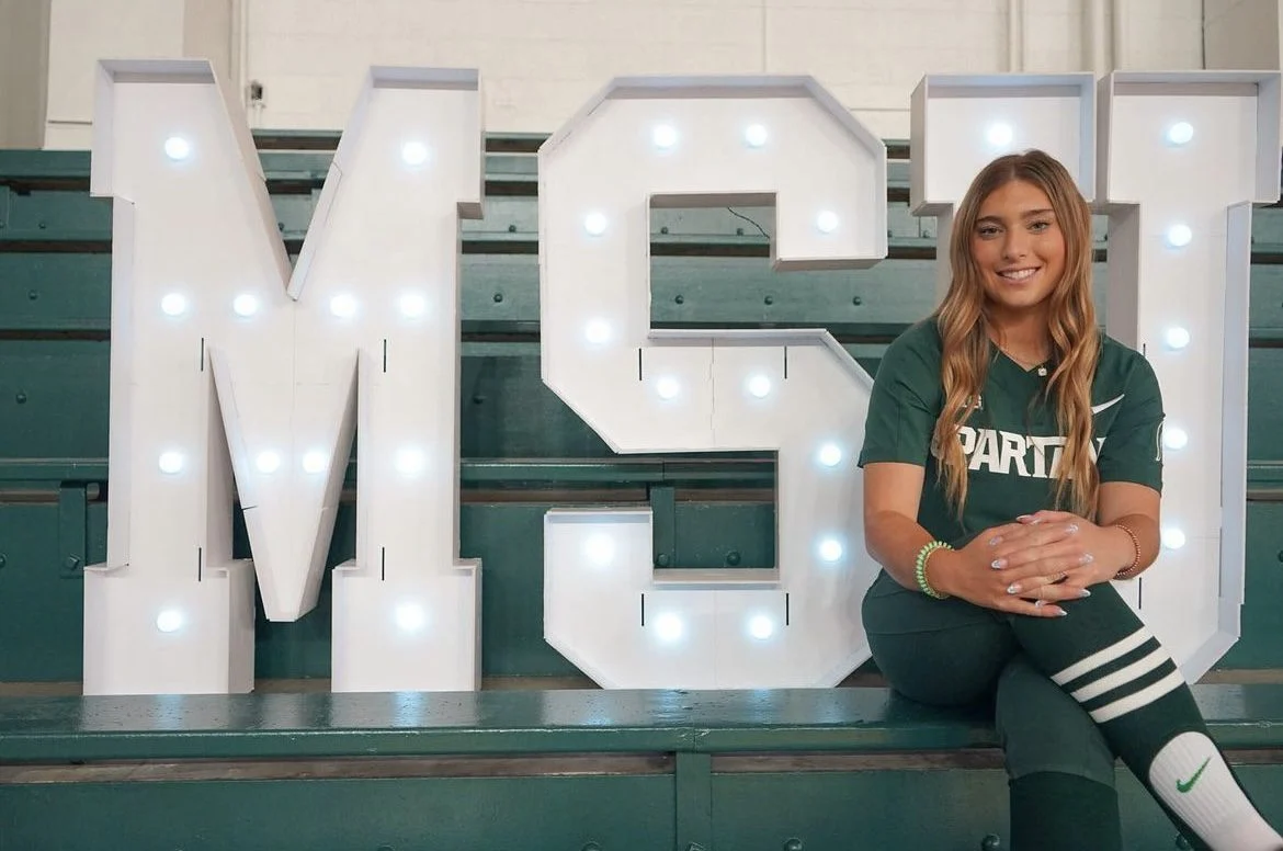 Sports Performance highlighted athlete sitting in front of an MSU marquee
