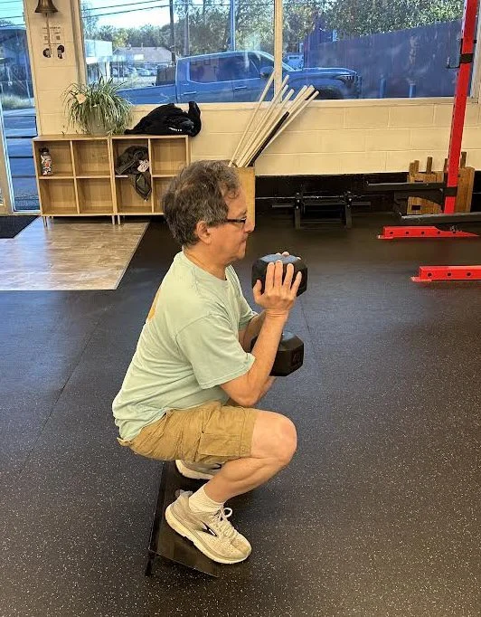 client does a goblet squat