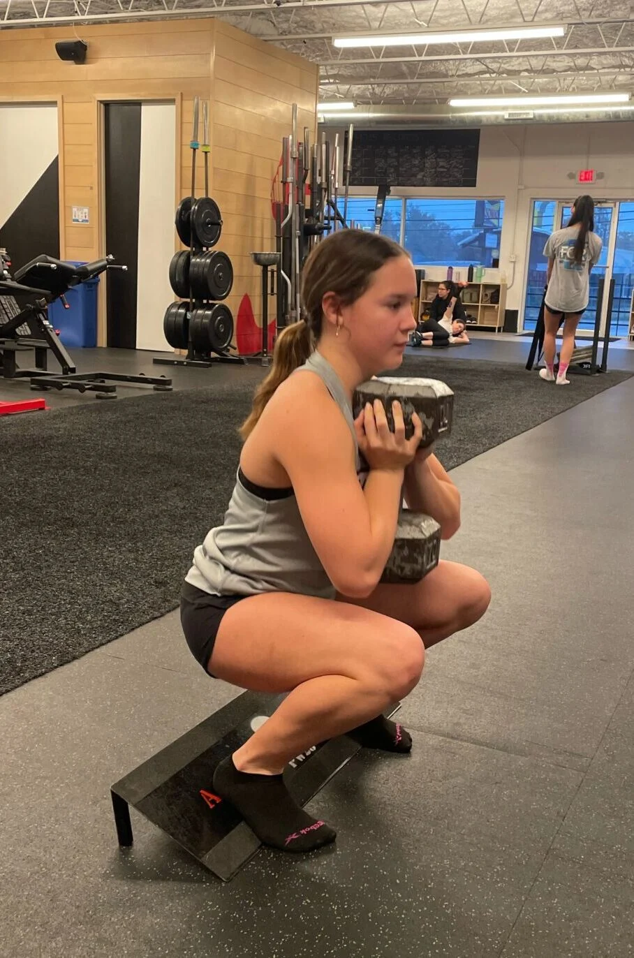 Sports Performance highlight Hannah doing a goblet squat on a slant board