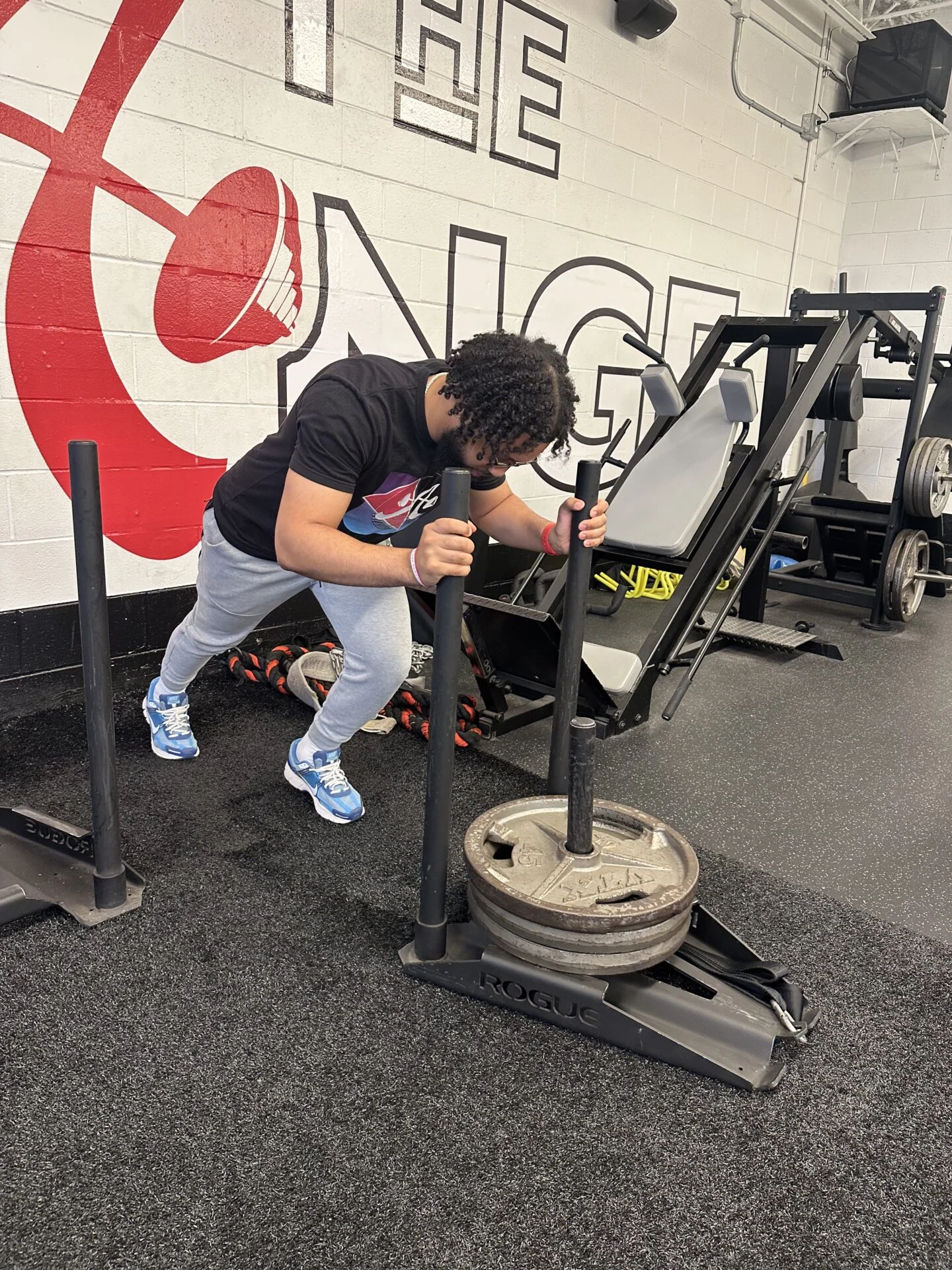 Personal trainer Daniel Taylor pushing a weight sled