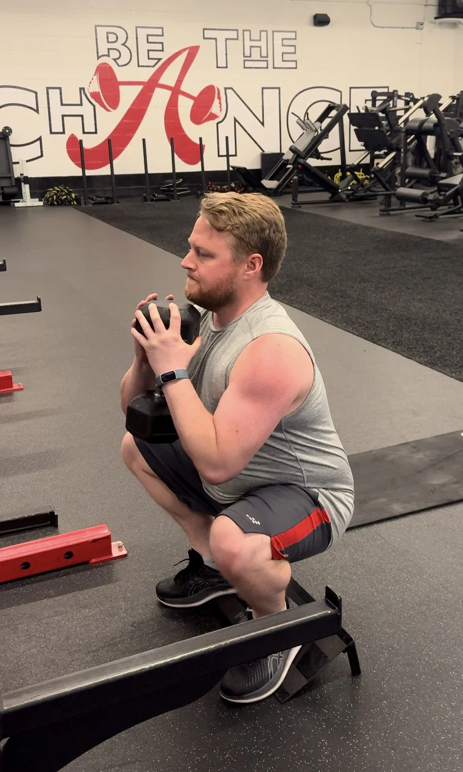 James doing a goblet squat on a slant board