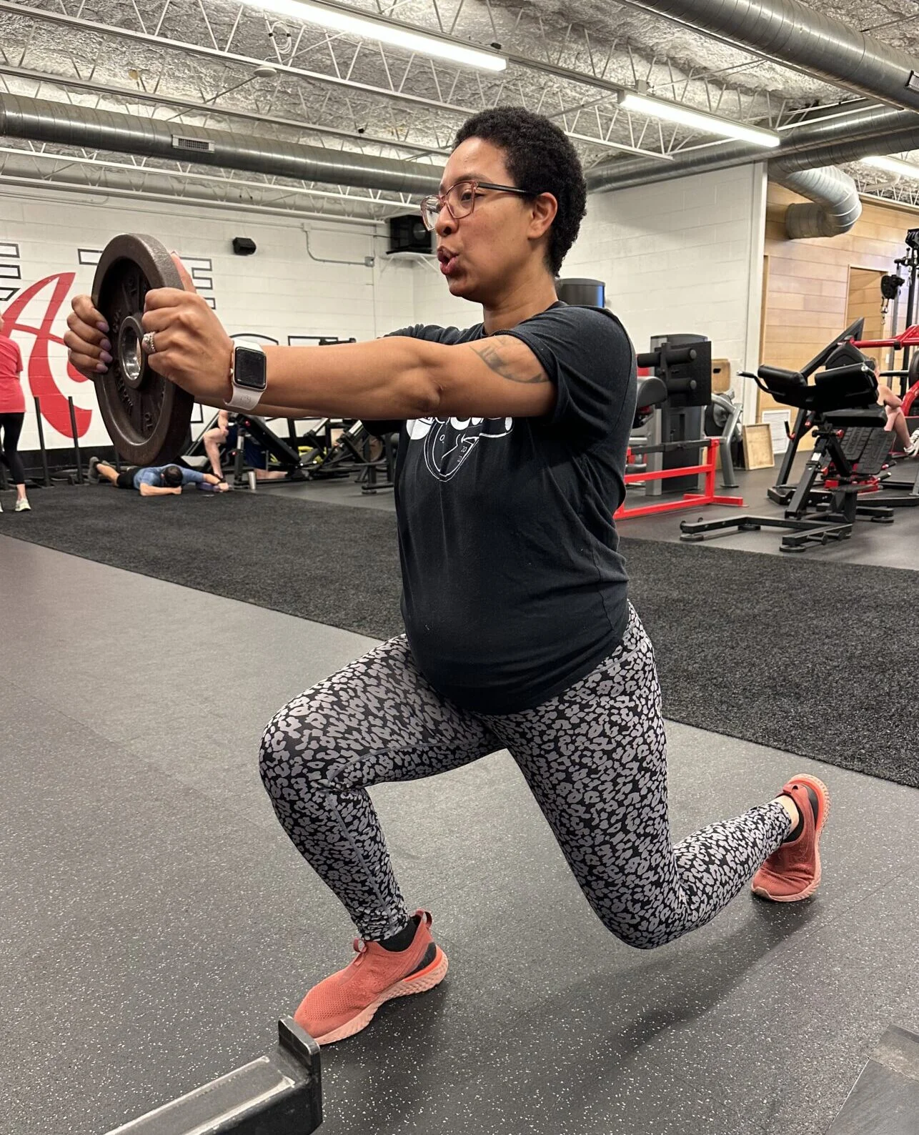 Personal trainer Kimi Adeigbe performing a lunge during her pregnancy