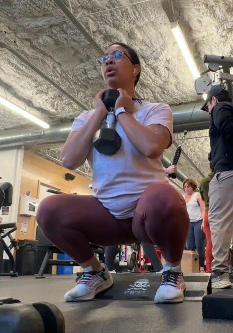 Personal trainer Kimi Adeigbe performing a goblet squat