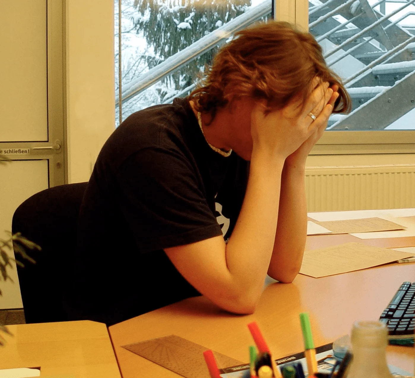 A person with their face in their hands