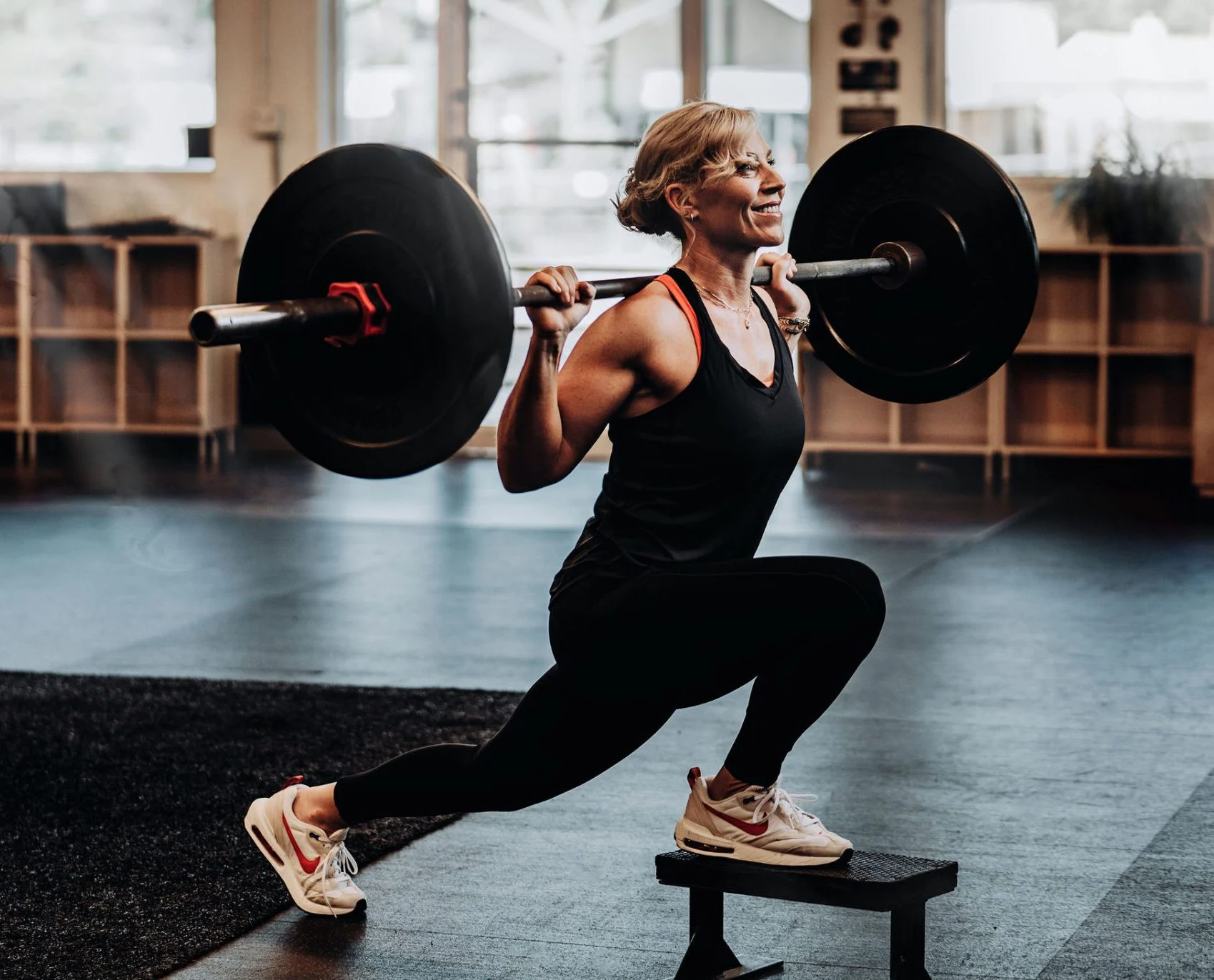 Krista Bergeron performing a barbell front foot elevated split squat