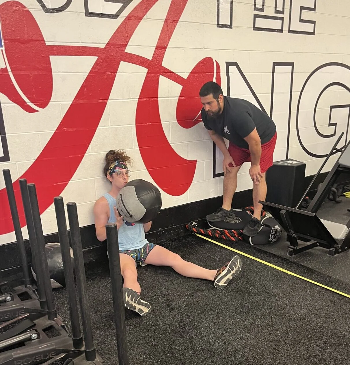 Brock doing a seated med ball toss at the Simply Fit Games