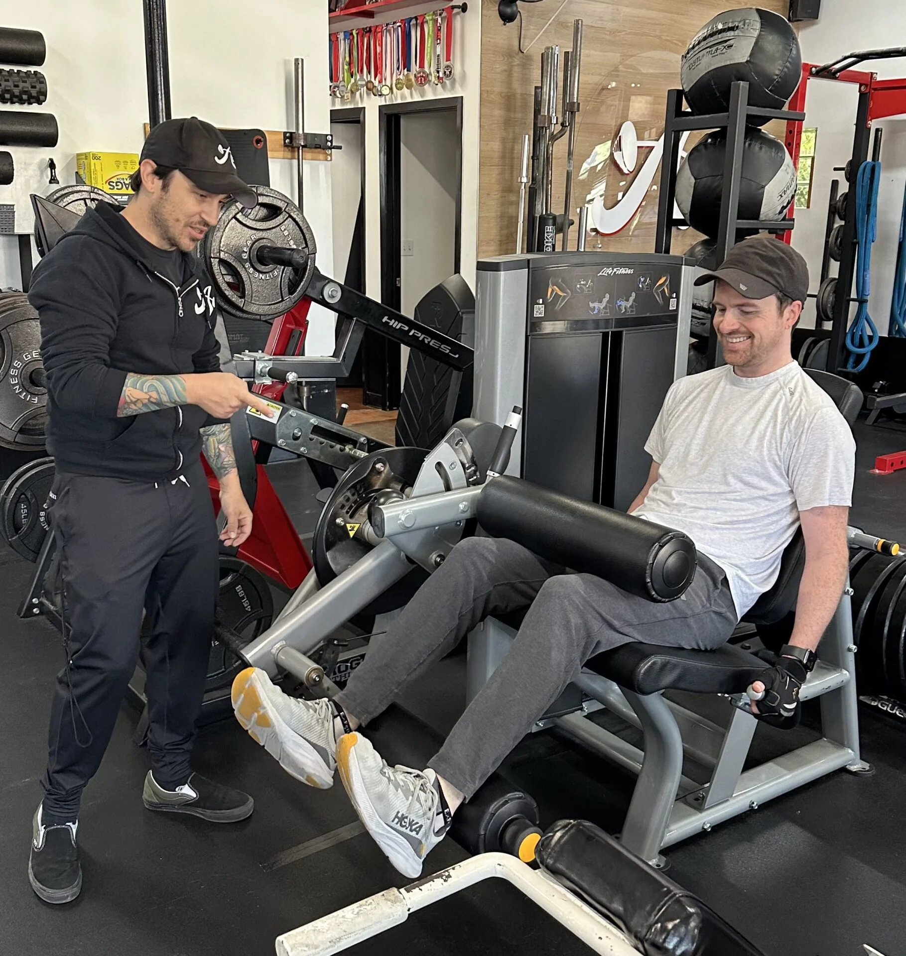 Jonny doing seated hamstring curls with his personal trainer, Nicky