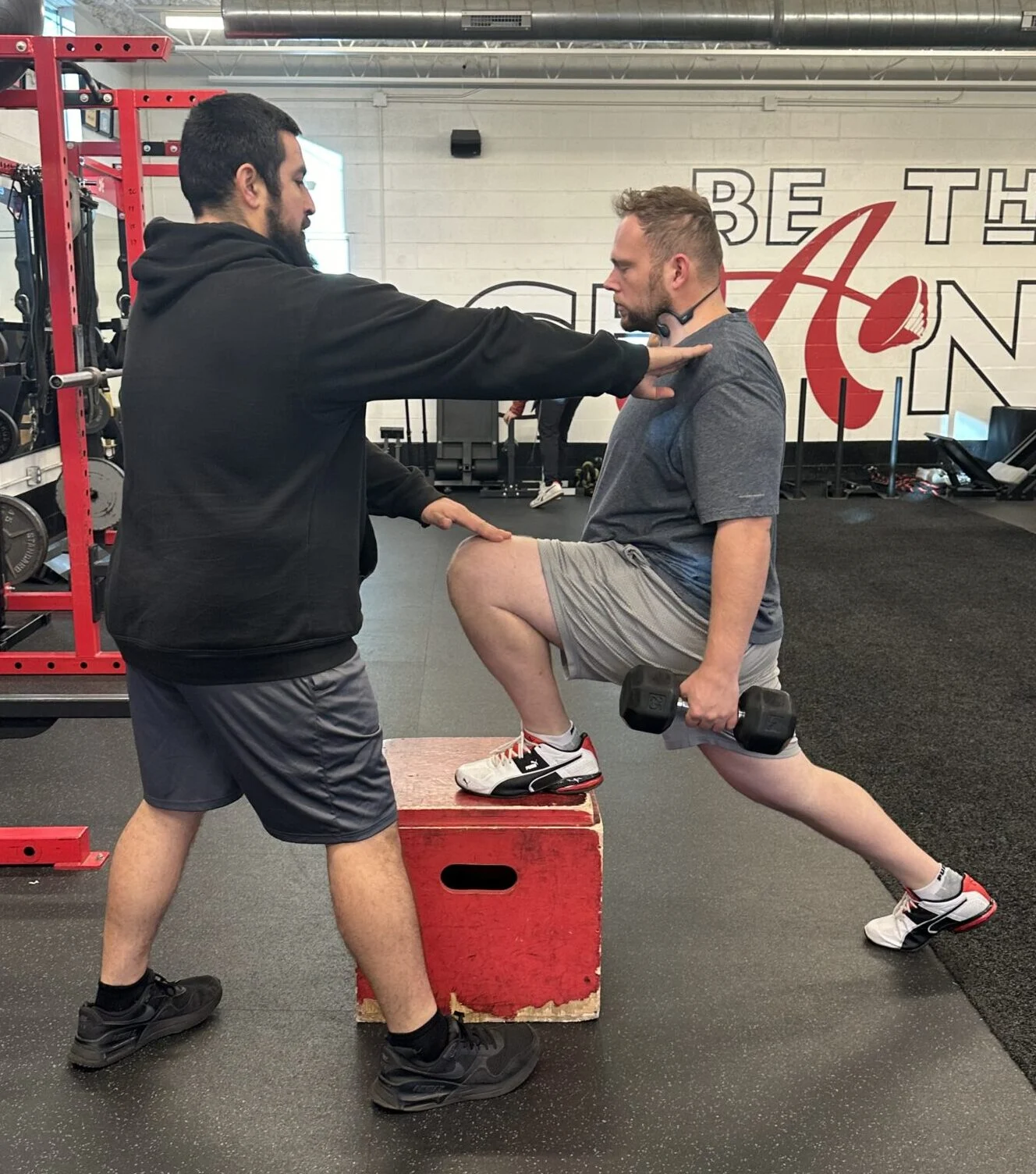 client highlight Timothy performs a split squat with his trainer Brendan