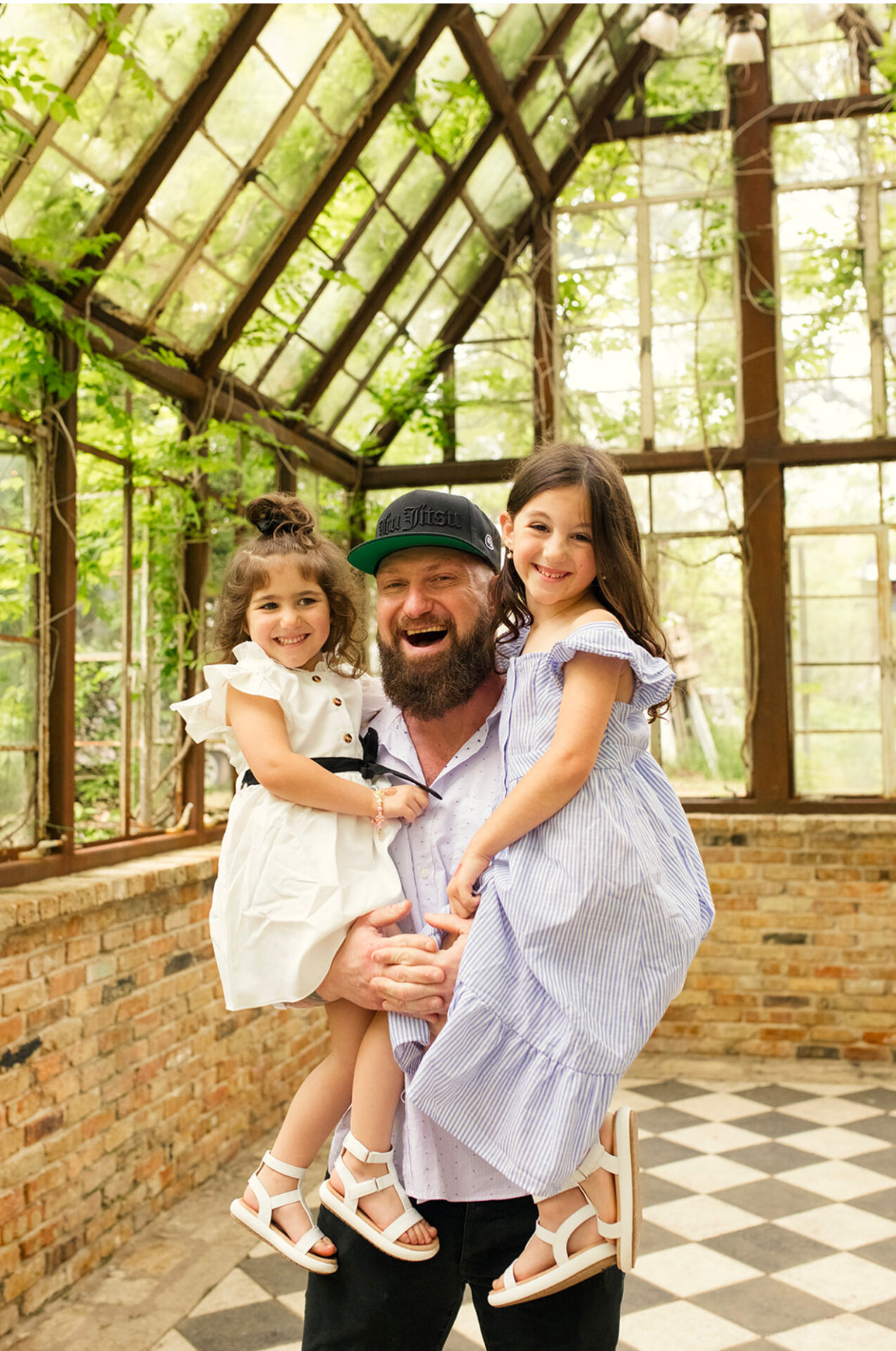 Featured trainer Mike holding his two daughters