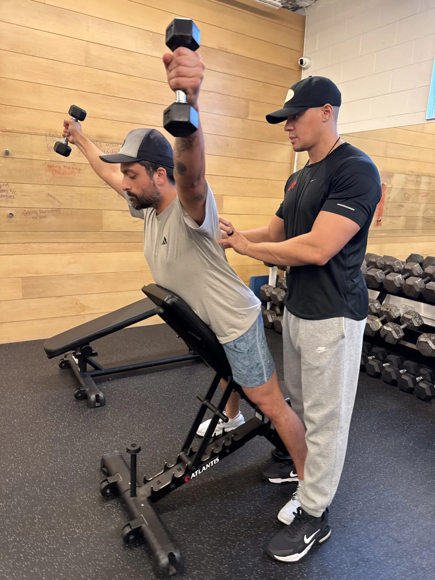 Guhan performing a dumbbell raise